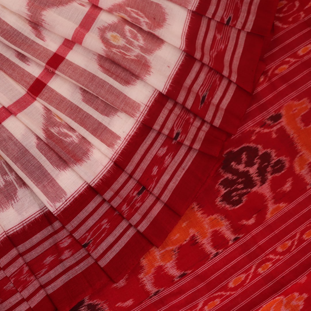 Full view of a white and red Sambalpuri cotton saree with traditional motifs.