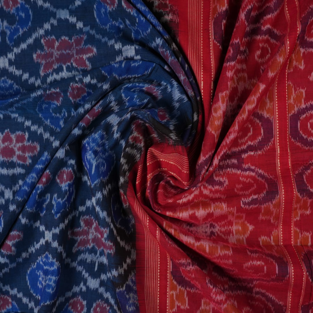 Full flat lay view of a blue and red Sambalpuri cotton saree showcasing the entire body and pallu design.