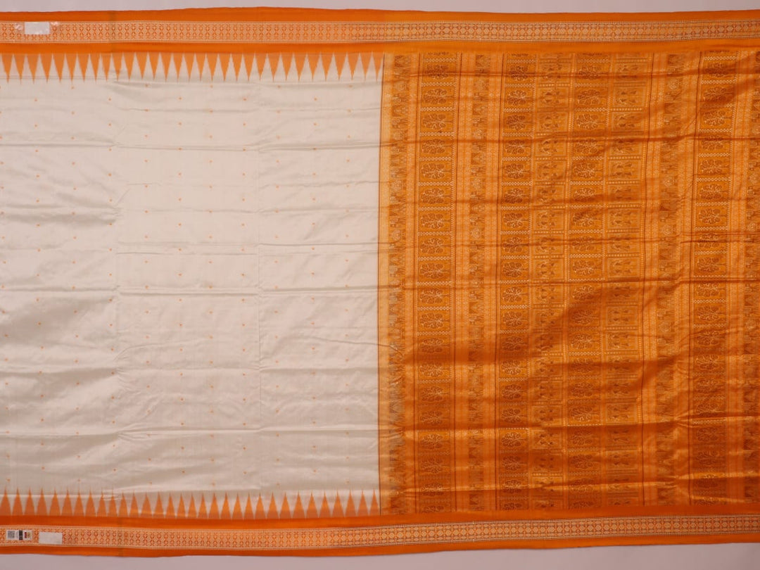 Close-up of Bomkai silk saree fabric texture in white with yellow butta pattern.