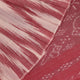 Model wearing a white and maroon Sambalpuri cotton saree with motifs, demonstrating a stylish drape.