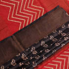 Close-up of the subtle slub and print on a handloom grey and rust Tussar silk saree fabric.