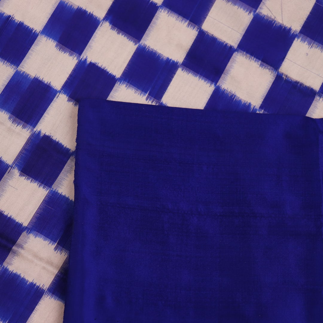 Close-up of the intricate Pasapalli pattern woven on a luxurious white silk Sambalpuri saree with blue accents.