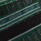 Black and green plain Sambalpuri cotton saree, gracefully draped.