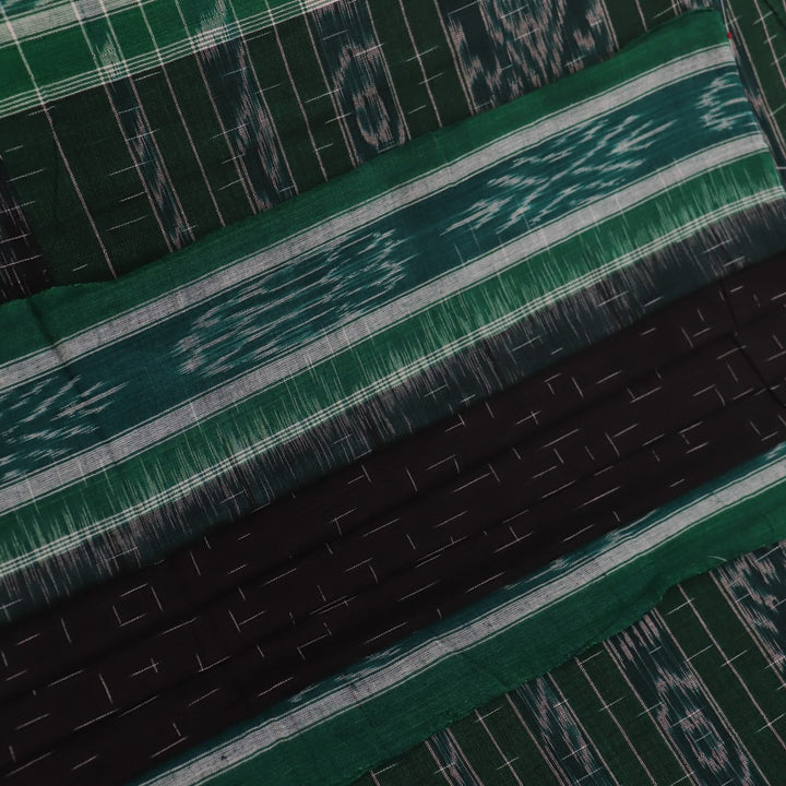 Black and green plain Sambalpuri cotton saree, gracefully draped.