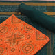 Blouse piece detail of an orange and green motif Sambalpuri cotton dress material.
