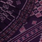 Elegantly draped red and violet Sambalpuri cotton saree with traditional motifs.
