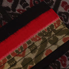 Green and black Sambalpuri cotton saree with motifs, elegantly draped for styling.