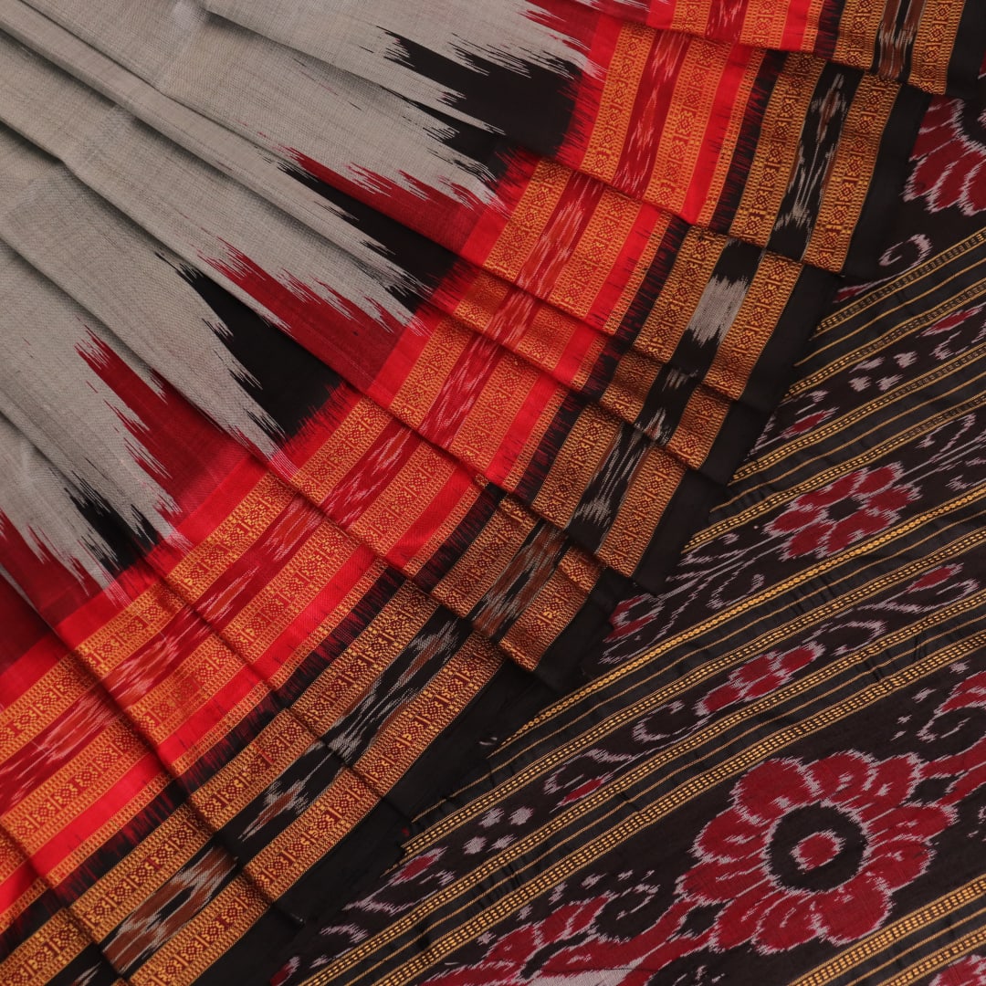 Saree draped: Grey Khandua silk saree with black butta pattern, showcasing elegant styling.