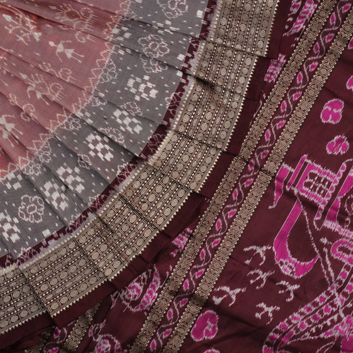 Close-up of the rich multi-color and maroon Sambalpuri silk fabric, highlighting its exquisite handloom weave texture.
