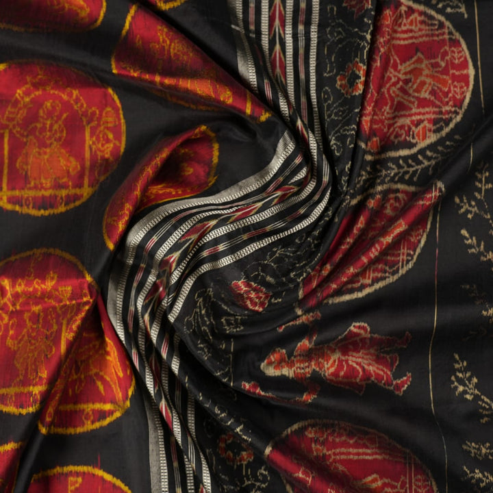 Close-up of the luxurious black Sambalpuri silk fabric, highlighting its rich texture and weave.
