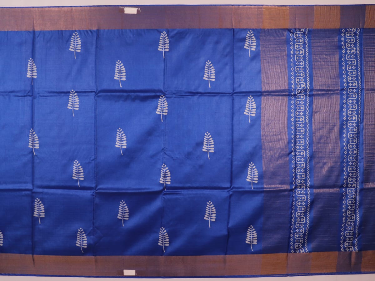 Close-up of blue printed Tussar silk handloom saree fabric texture.
