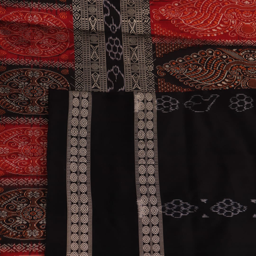 Detailed texture of handwoven Bomkai silk saree fabric in maroon and black with butta pattern.