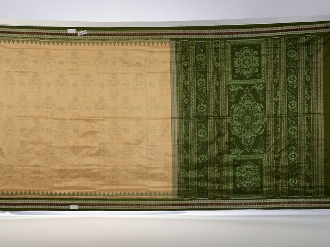 Extreme close-up of cream Sambalpuri silk saree showing exquisite handloom weave texture.