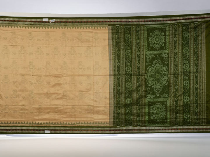 Extreme close-up of cream Sambalpuri silk saree showing exquisite handloom weave texture.