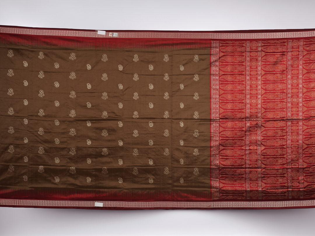 Close-up of Bomkai Silk Saree fabric, highlighting its luxurious brown silk texture and intricate weave.