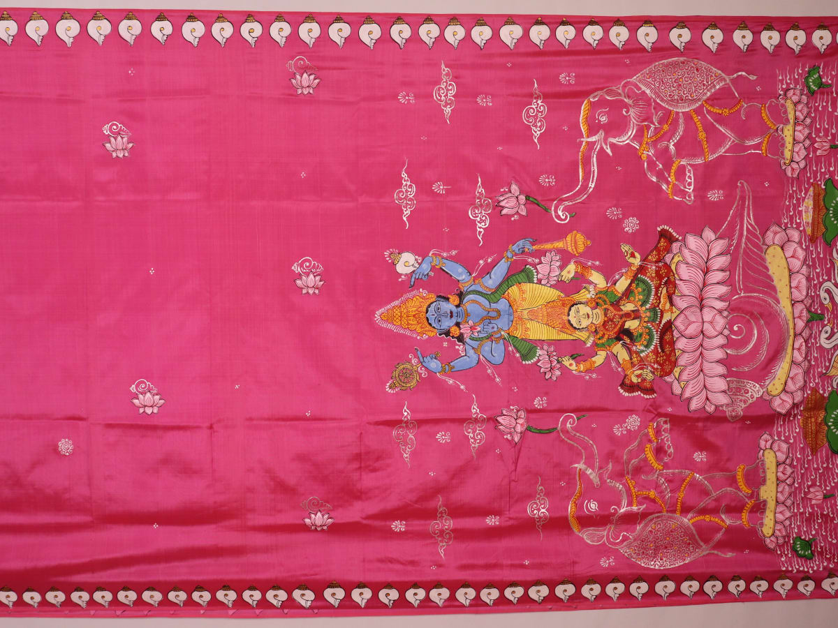 Close-up of pink silk Patachitra saree fabric, showcasing hand-painted texture and fine details.