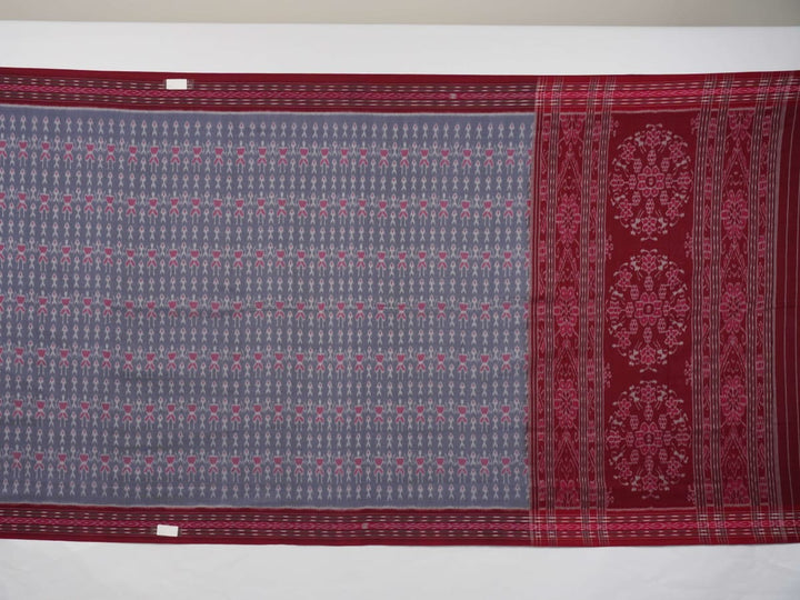Elegant styling of a grey and maroon Sambalpuri cotton saree with hand-woven ikat motifs draped on a model.