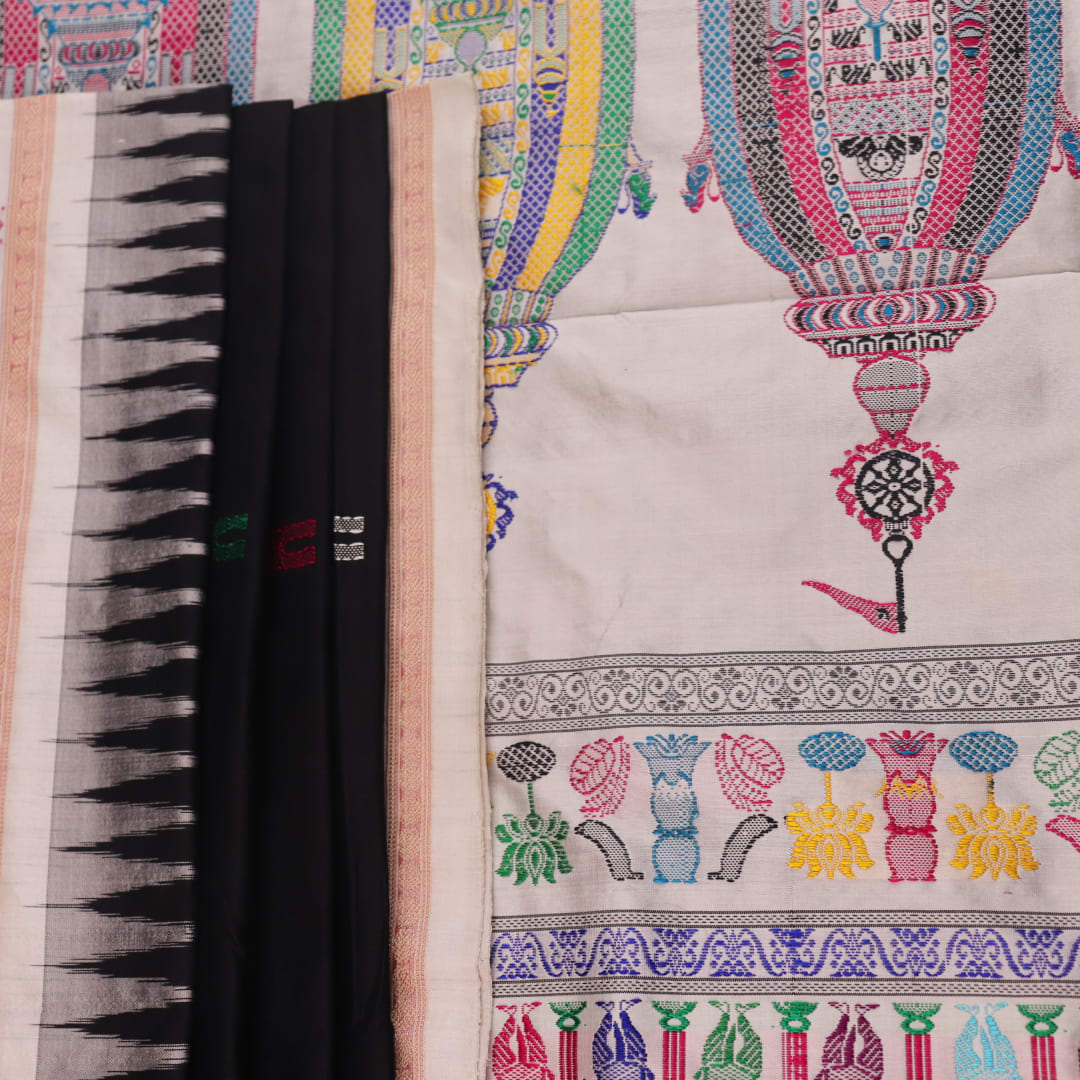 Close-up texture of black and white Bomkai silk saree with butta pattern.