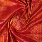 Close-up of rust Sambalpuri silk fabric, revealing its luxurious texture and fine handloom weave.