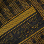 Close-up of the black Sambalpuri silk saree fabric, revealing its rich texture and the intricate weave of the motifs.