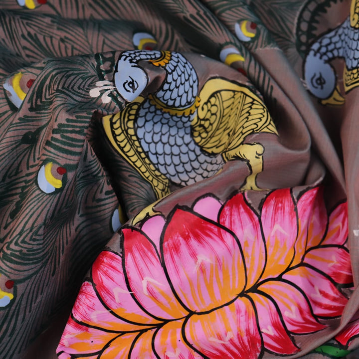 Close-up of hand-painted silk Patachitra saree fabric texture, showing the multicolor details and fine weave.