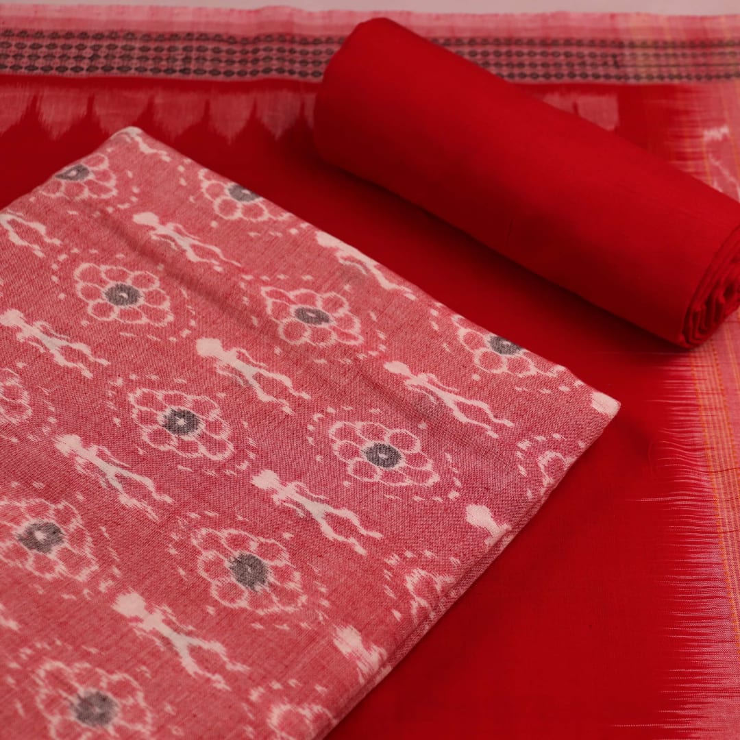 Close-up of red and pink cotton Sambalpuri dress material with intricate motifs.