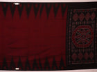 Gracefully draped maroon and black plain Sambalpuri cotton saree.