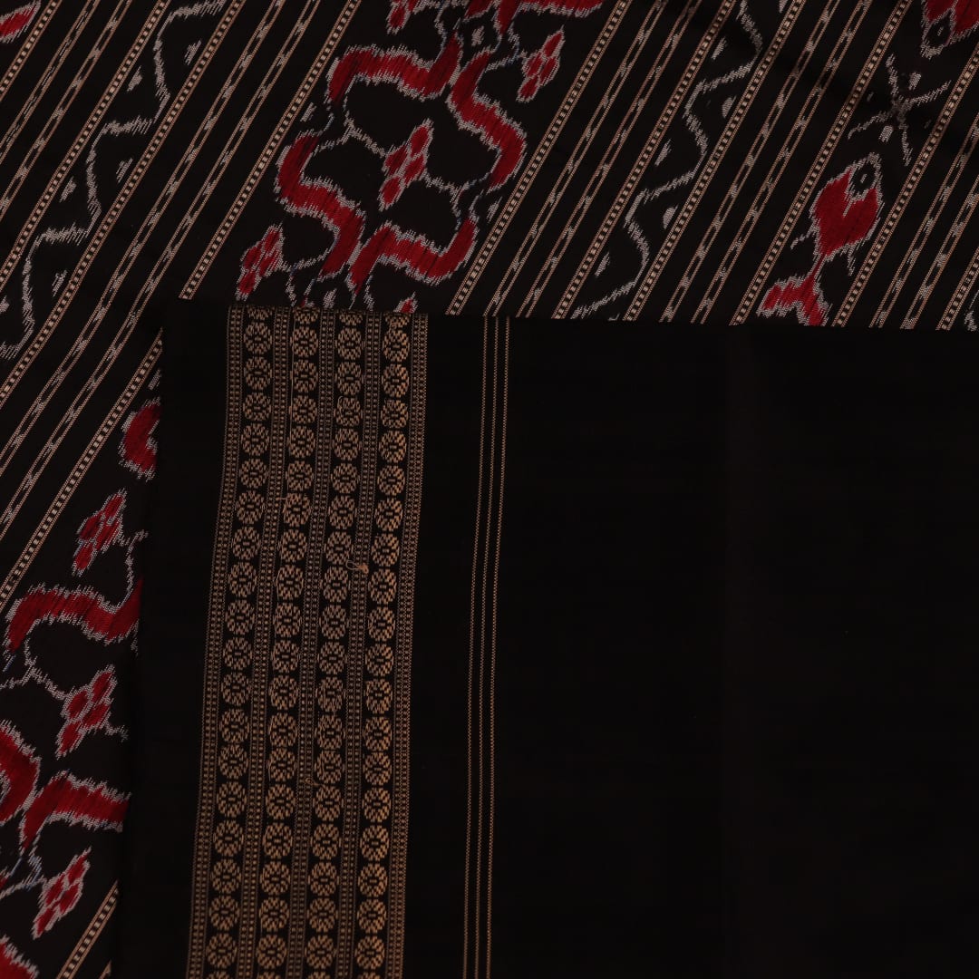 Close-up showing the fine silk texture and intricate motifs of the Sambalpuri saree