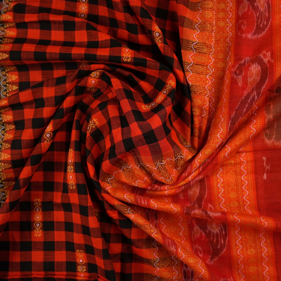 Full layout view of a black and orange Sambalpuri cotton saree showing the body, border, and pallu