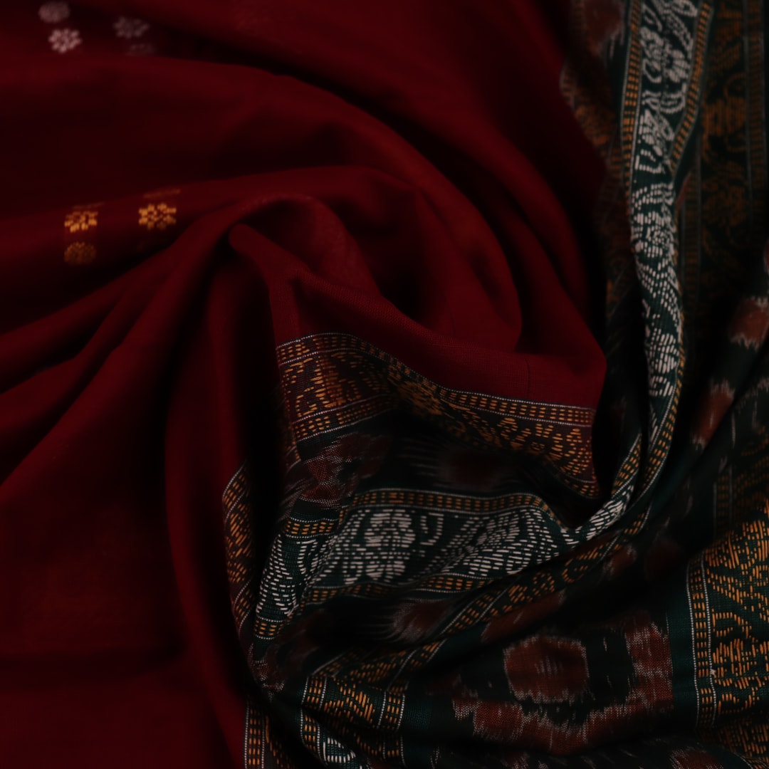 Full view of a maroon cotton Bomkai saree with green butta pattern throughout.