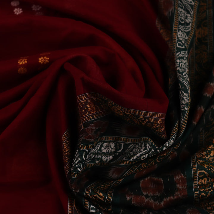 Full view of a maroon cotton Bomkai saree with green butta pattern throughout.