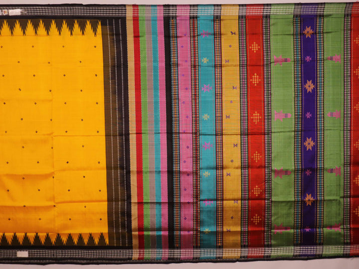 Close-up view of the golden silk fabric with black butta pattern of a Berhampuri silk saree