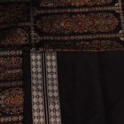 Detailed close-up of the red and black Bomkai silk saree fabric texture, featuring a butta pattern.