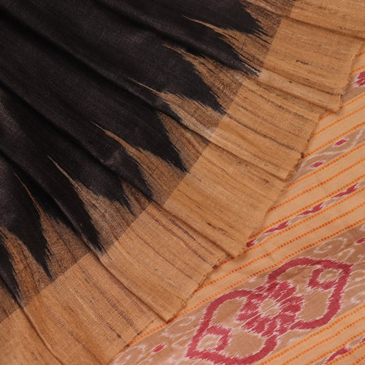 Close-up of black and cream tussar silk sari fabric showing the plain texture.