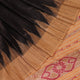 Close-up of black and cream tussar silk sari fabric showing the plain texture.