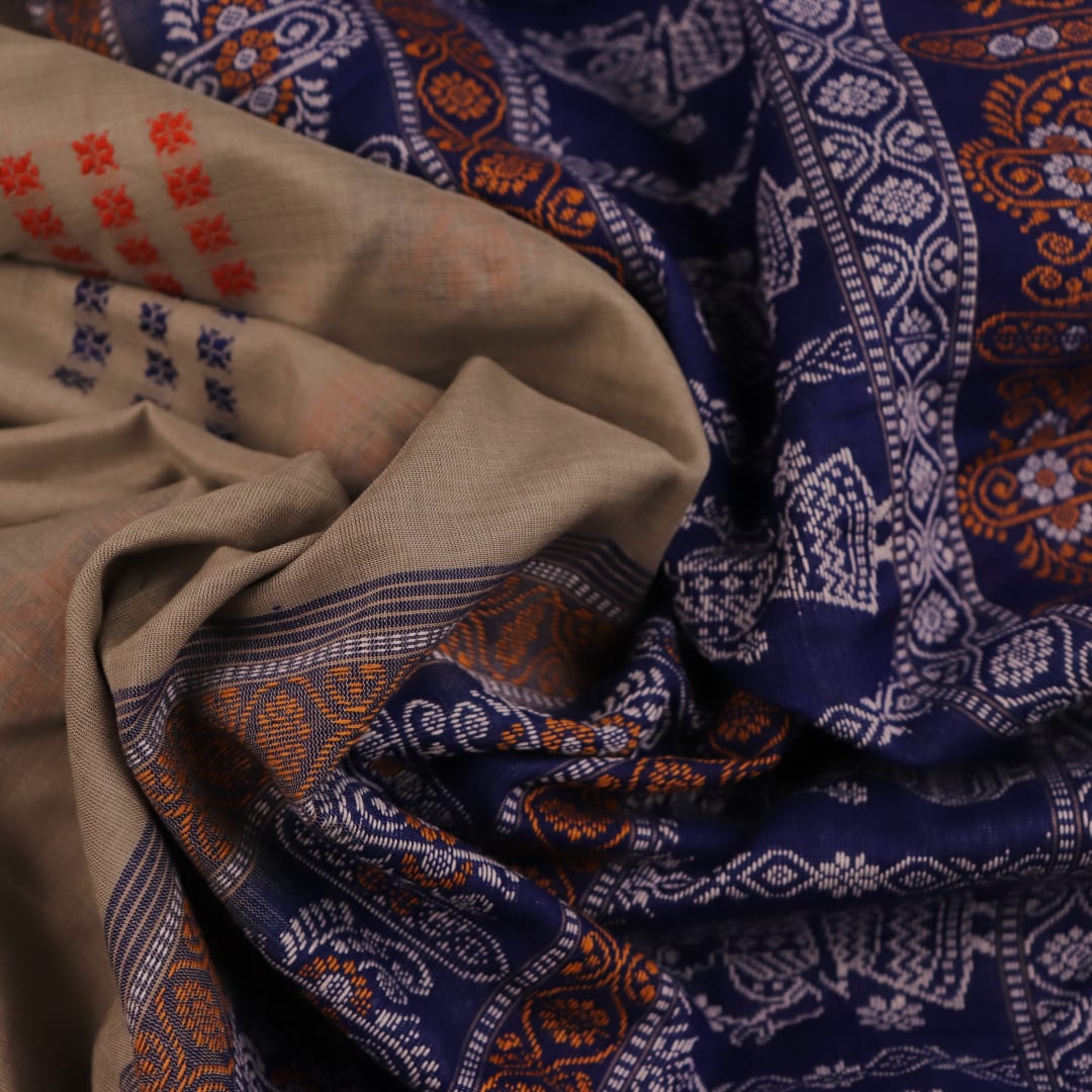 Full view of a handloom Bomkai saree in grey and blue with butta motifs.