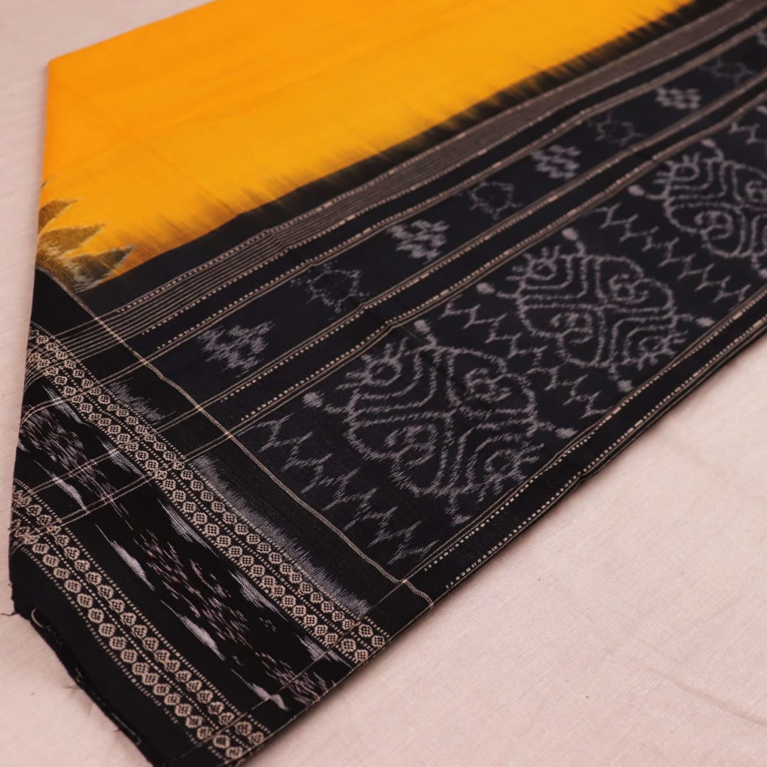 Yellow and black Sambalpuri cotton dupatta draped on a woman