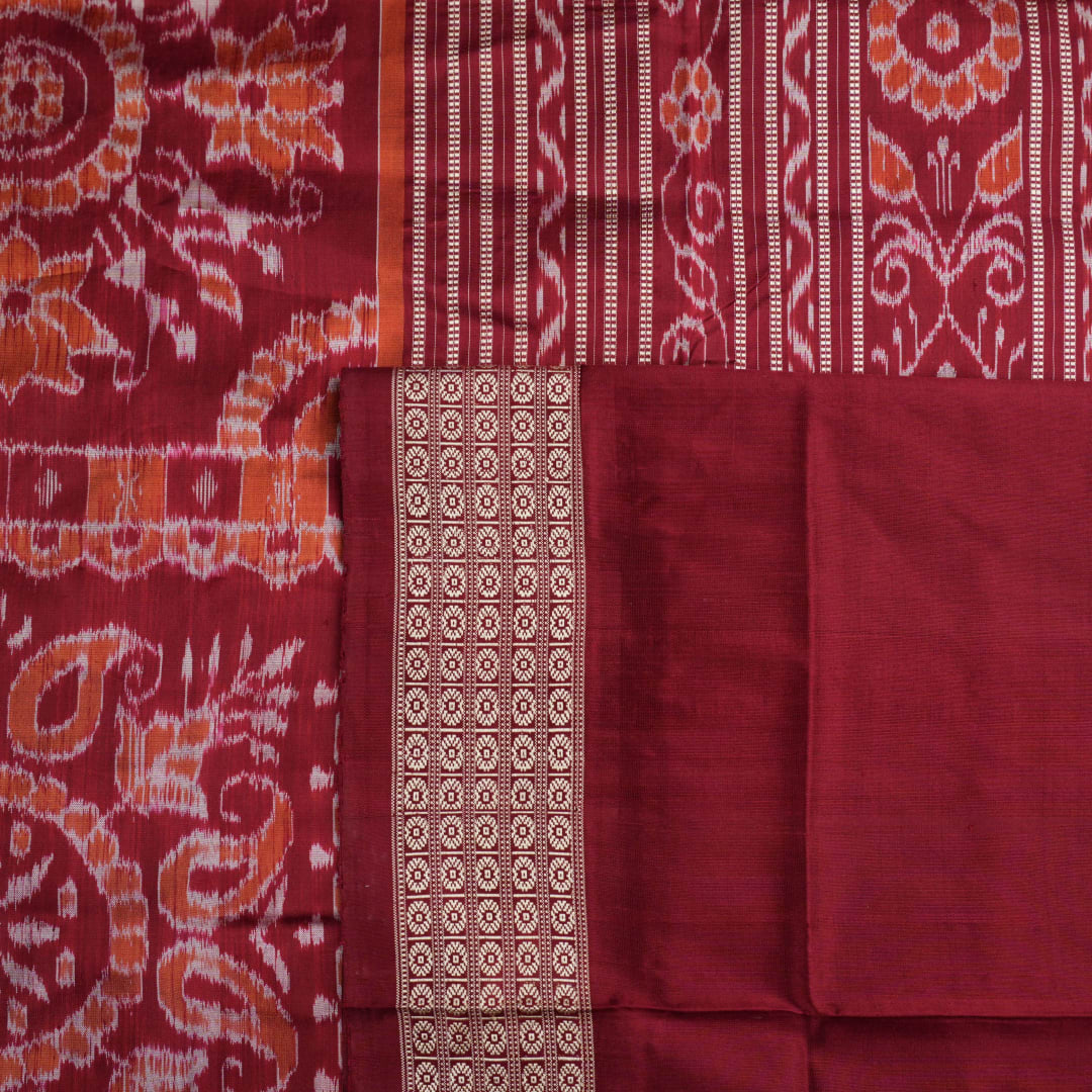 Close-up of the Sambalpuri silk saree fabric, detailing its luxurious texture and fine handloom weave.