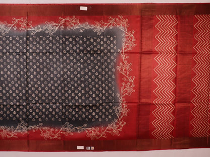 Close-up of the subtle slub and print on a handloom grey and rust Tussar silk saree fabric.