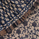Close-up of blue printed Tussar silk saree fabric texture.