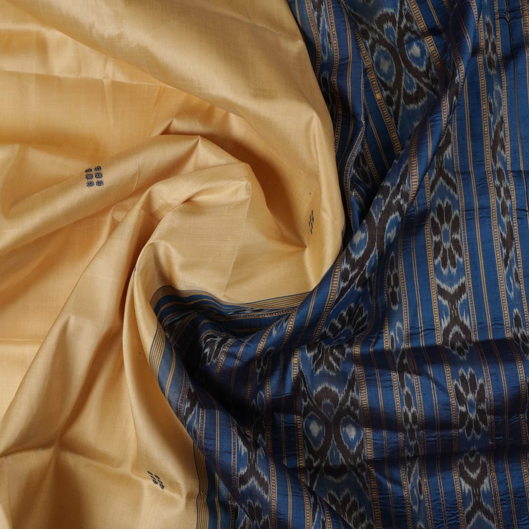 Elegant styling of cream and blue Khandua silk saree with butta pattern on model for traditional look