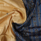 Elegant styling of cream and blue Khandua silk saree with butta pattern on model for traditional look