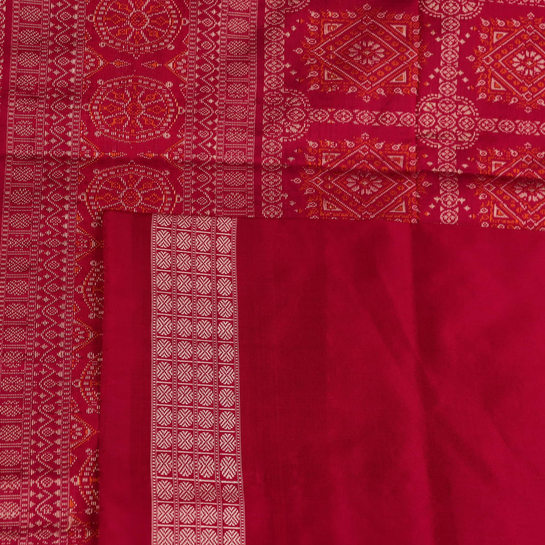 Textured close-up of green Bomkai silk saree fabric, revealing intricate weave and magenta butta pattern.