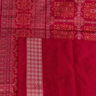 Textured close-up of green Bomkai silk saree fabric, revealing intricate weave and magenta butta pattern.
