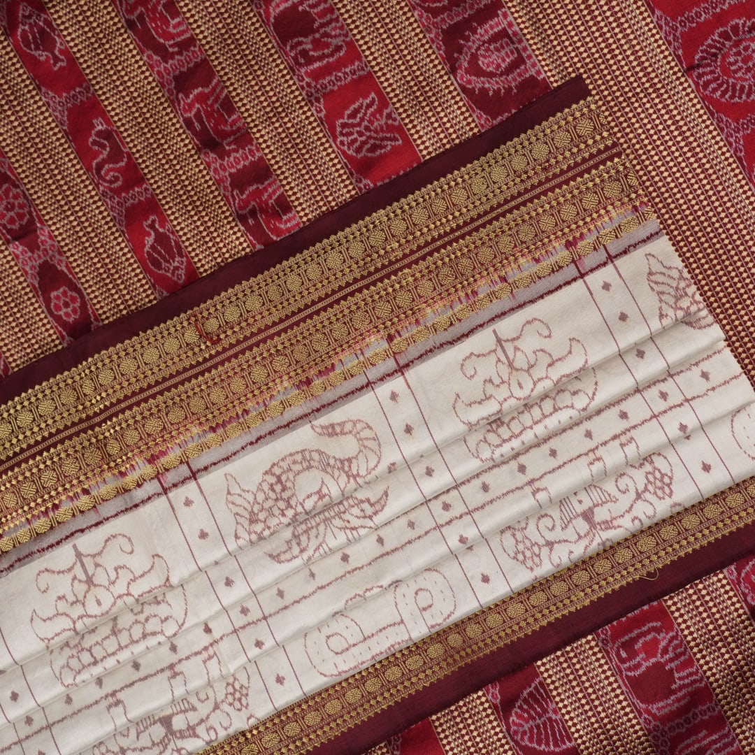 Close-up of the fine silk texture of the white Sambalpuri saree, highlighting its soft sheen and weave.