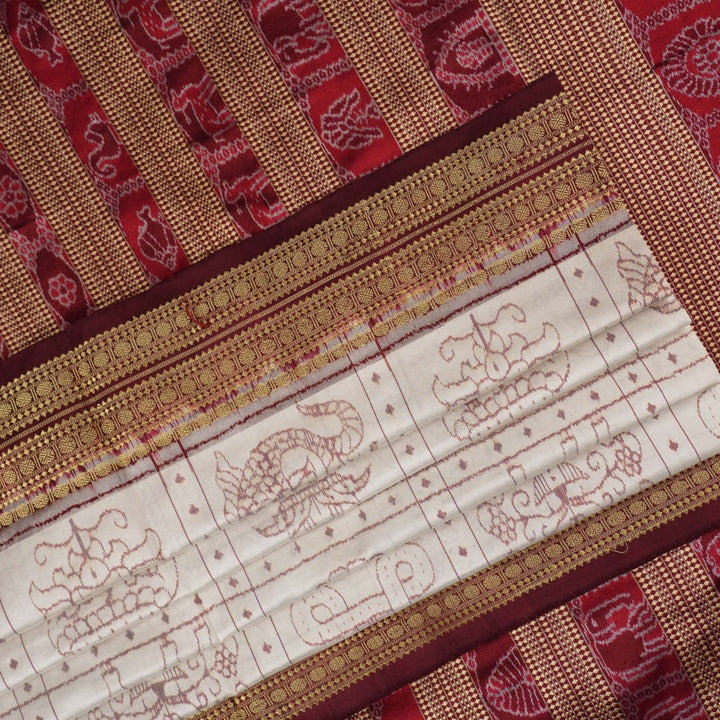 Close-up of the fine silk texture of the white Sambalpuri saree, highlighting its soft sheen and weave.