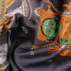 Close-up of handloom grey silk Patachitra saree fabric texture, revealing the intricate details of the hand-painted design.