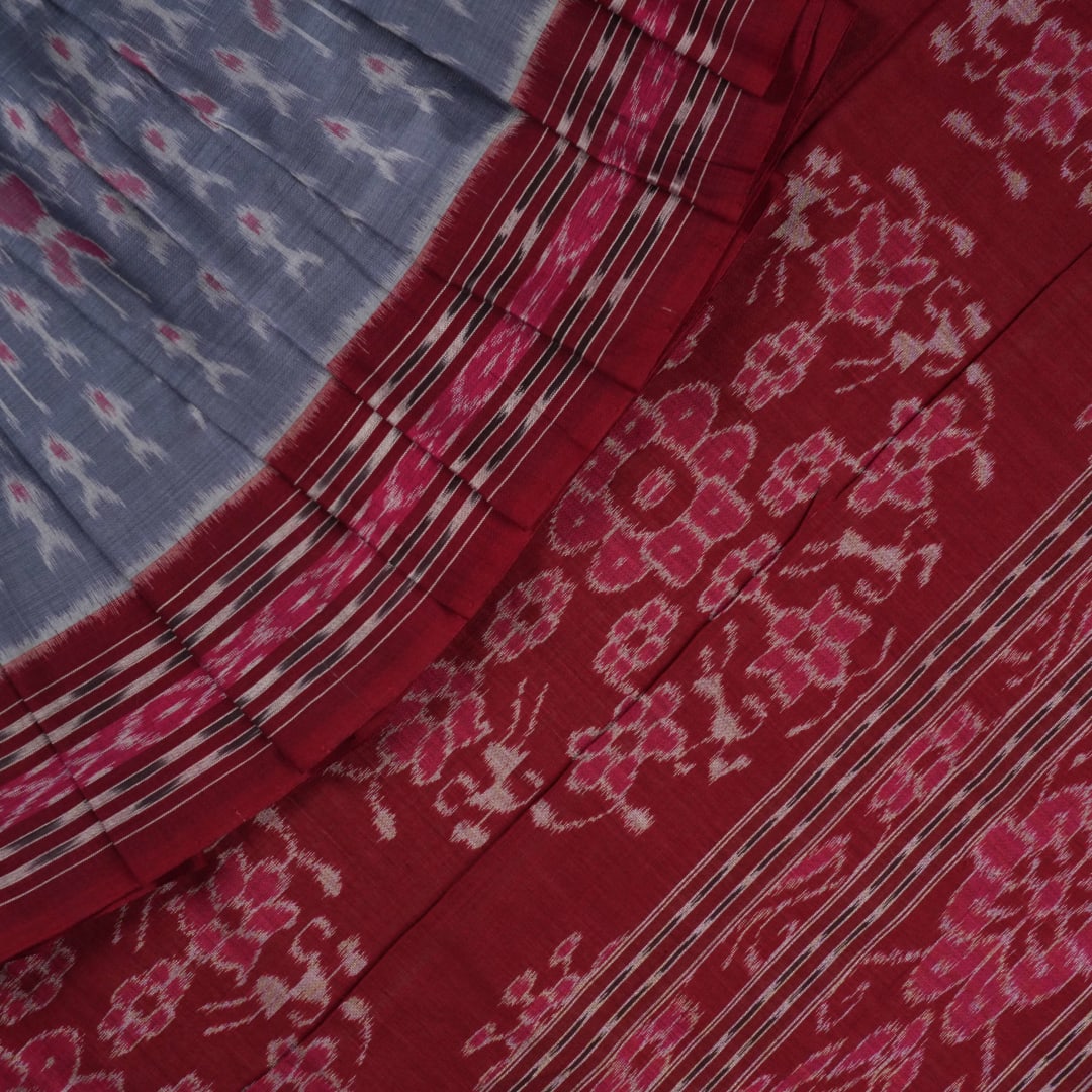 Elegant styling of a grey and maroon Sambalpuri cotton saree with hand-woven ikat motifs draped on a model.