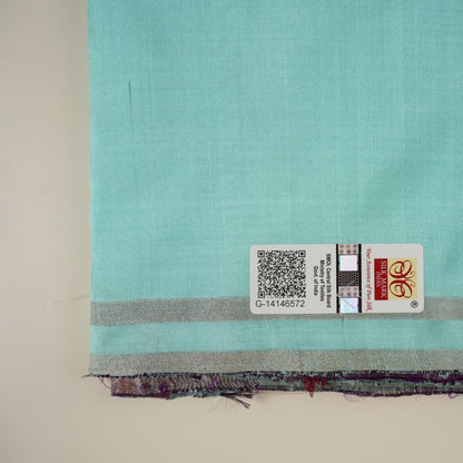Ultra close-up of the luxurious green Sambalpuri handloom silk weave, highlighting its smooth texture.