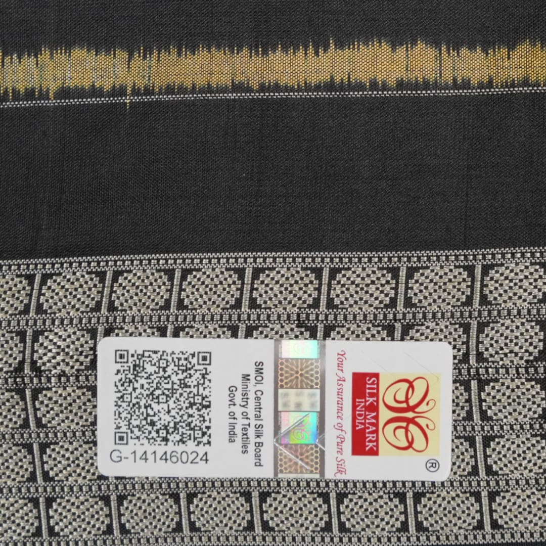 Close-up of the lustrous black Sambalpuri silk fabric, revealing its luxurious texture and fine weave.